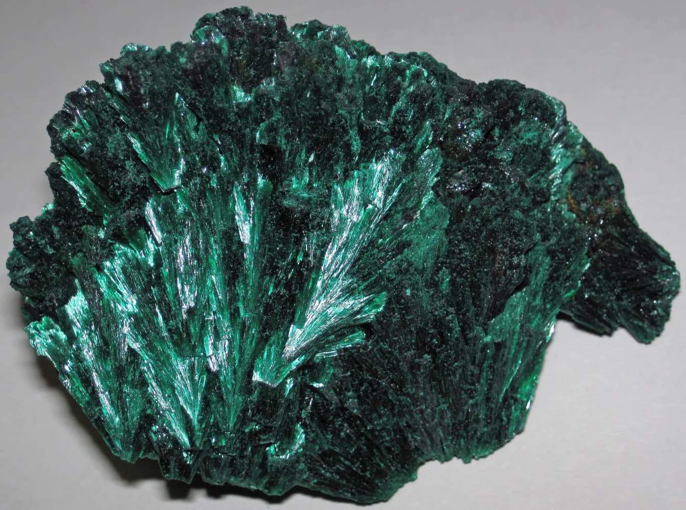 Green radiating fibrous malachite hand specimen